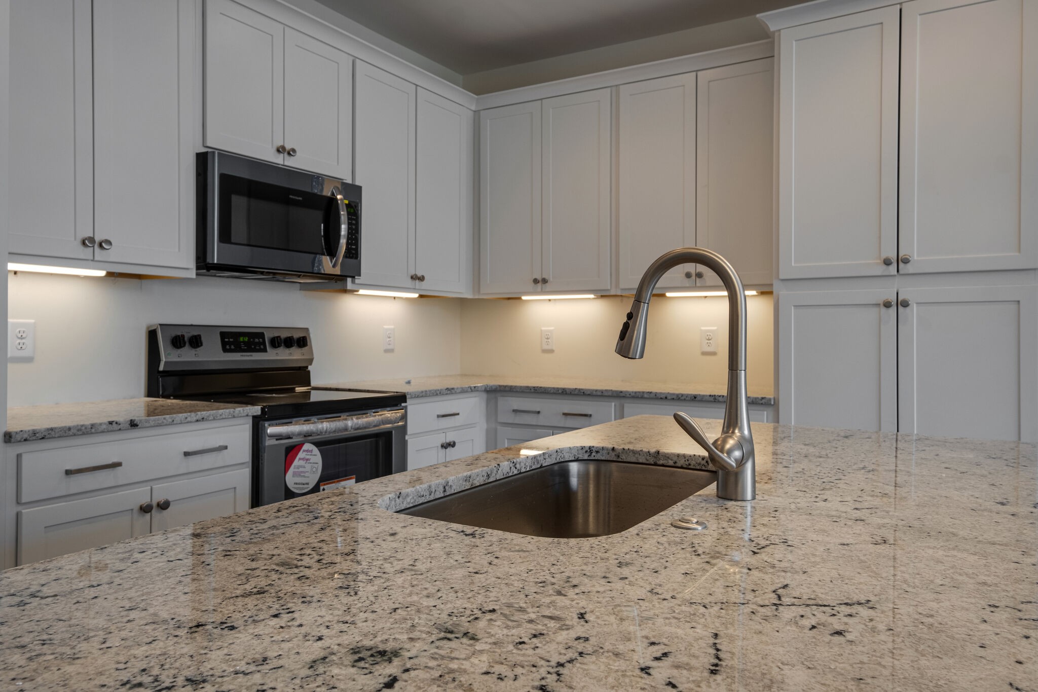 9 The Greens Springfield, TN 37172 - Photo 8 of 30 a kitchen with stainless steel appliances granite countertop a sink a stove a microwave and cabinets