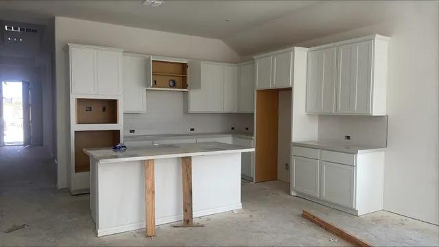 a kitchen with a stove and a refrigerator