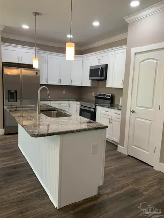 a kitchen with a sink and a stove top oven