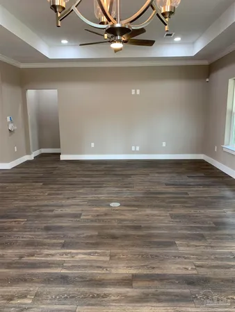 a view of an empty room and wooden floor