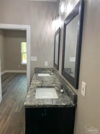 an empty room with a window and wooden floor