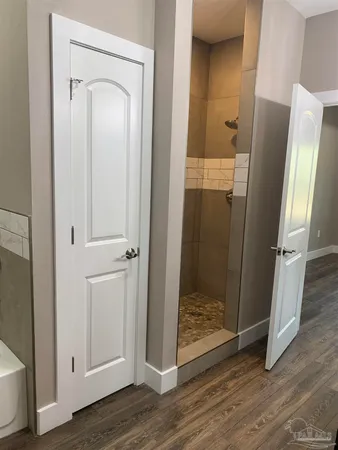 a view of an empty room with wooden floor