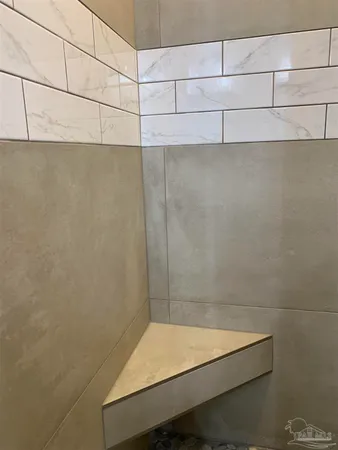 a bathroom with a granite countertop toilet sink and mirror