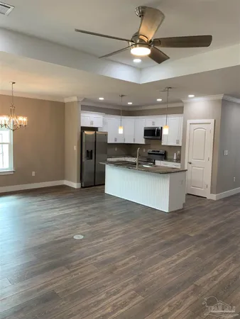 a kitchen with stainless steel appliances granite countertop a sink a refrigerator and a stove