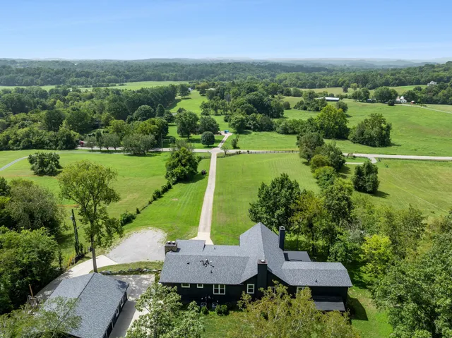 an aerial view of a house with yard swimming pool and outdoor seating