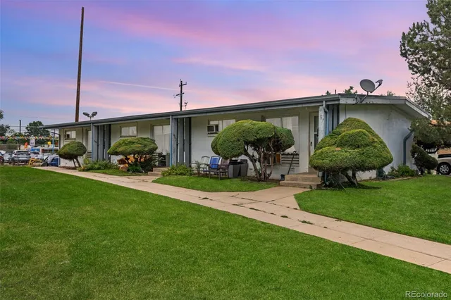 a view of a porch with furniture and a yard