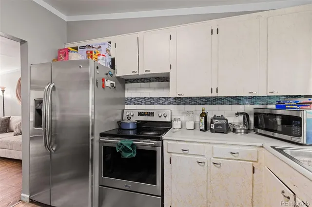 a kitchen with stainless steel appliances granite countertop a refrigerator and a stove