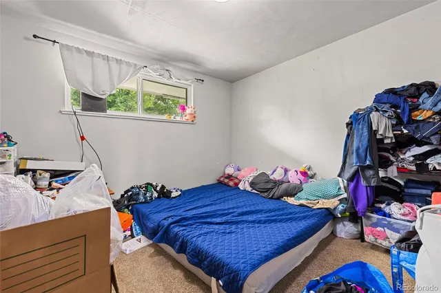 a bed room with a bed and a window