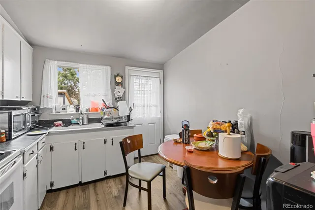 a view of a kitchen with a dining table and chairs