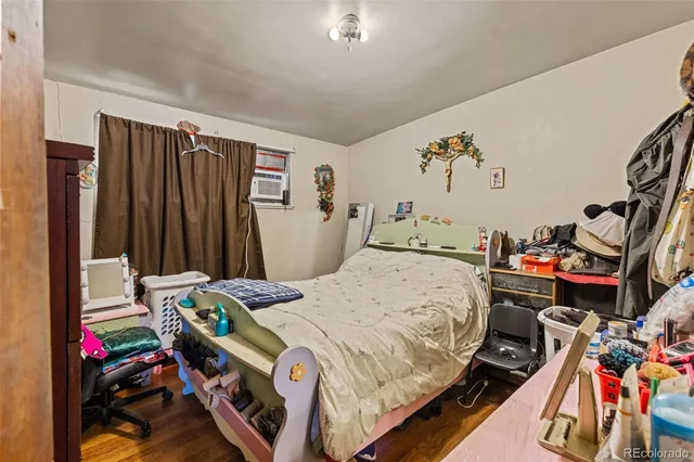a bedroom that has a bed and a desk in it