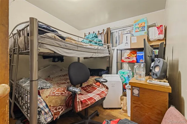 a bedroom with furniture and a closet