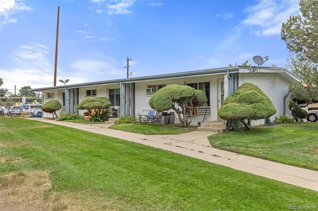a view of a porch with furniture and a yard