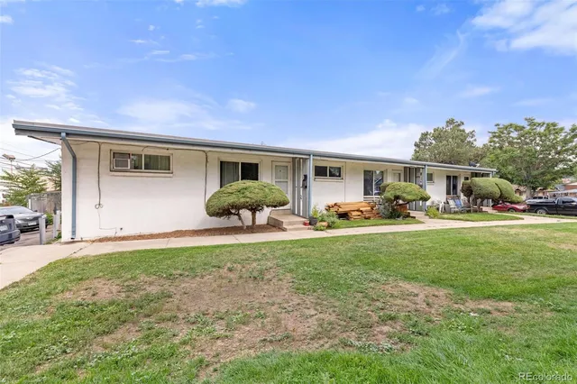 a front view of house with yard and outdoor seating