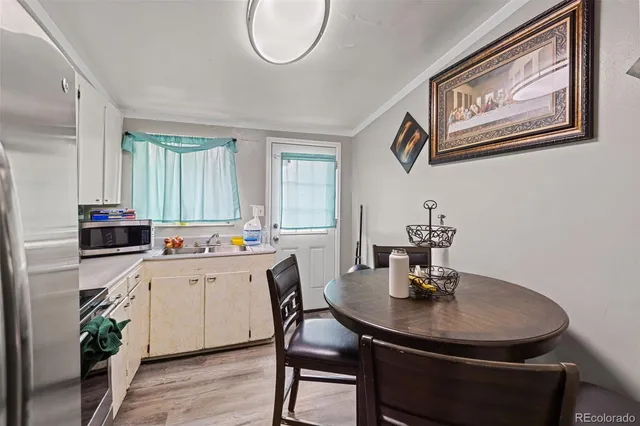 a kitchen with a sink cabinets and wooden floor