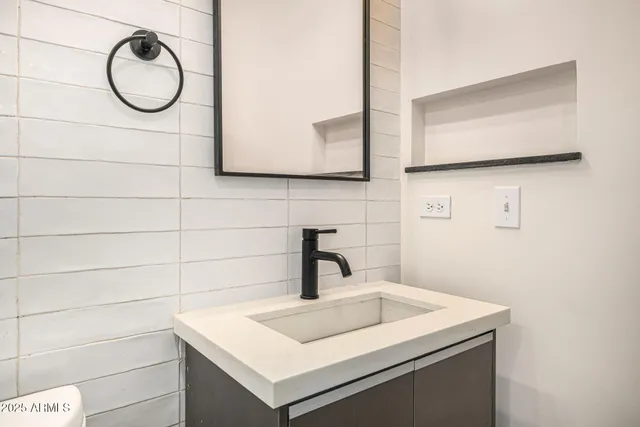 a bathroom with a sink and a mirror