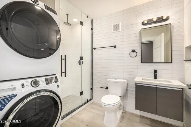 a spacious bathroom with a toilet a sink and mirror