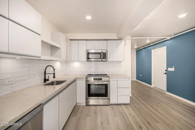 a kitchen with granite countertop a stove and a sink
