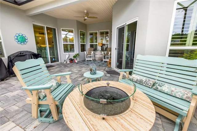 a living room with furniture a chandelier and a wooden floor