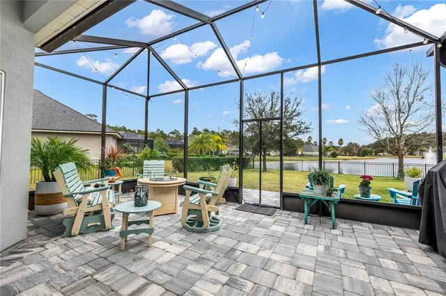 an aerial view of a swimming pool with yard