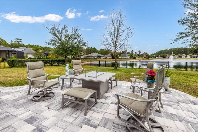 a view of a house with pool and lawn chairs