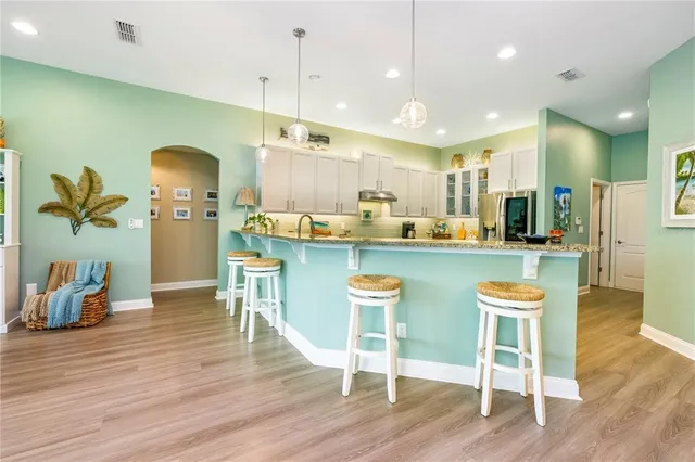 a view of a dining room with furniture and wooden floor
