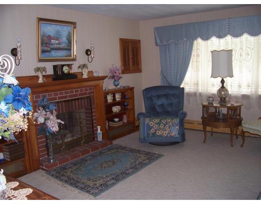 74 Kaufman Road Somerset, MA 02726 - Photo 3 of 12 a living room with furniture and a fireplace