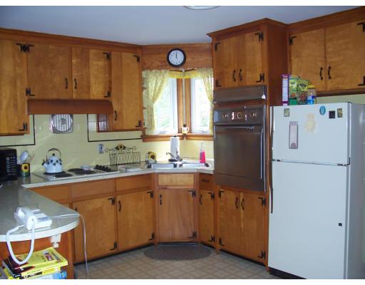 74 Kaufman Road Somerset, MA 02726 - Photo 5 of 12 a kitchen with a sink a refrigerator and cabinets