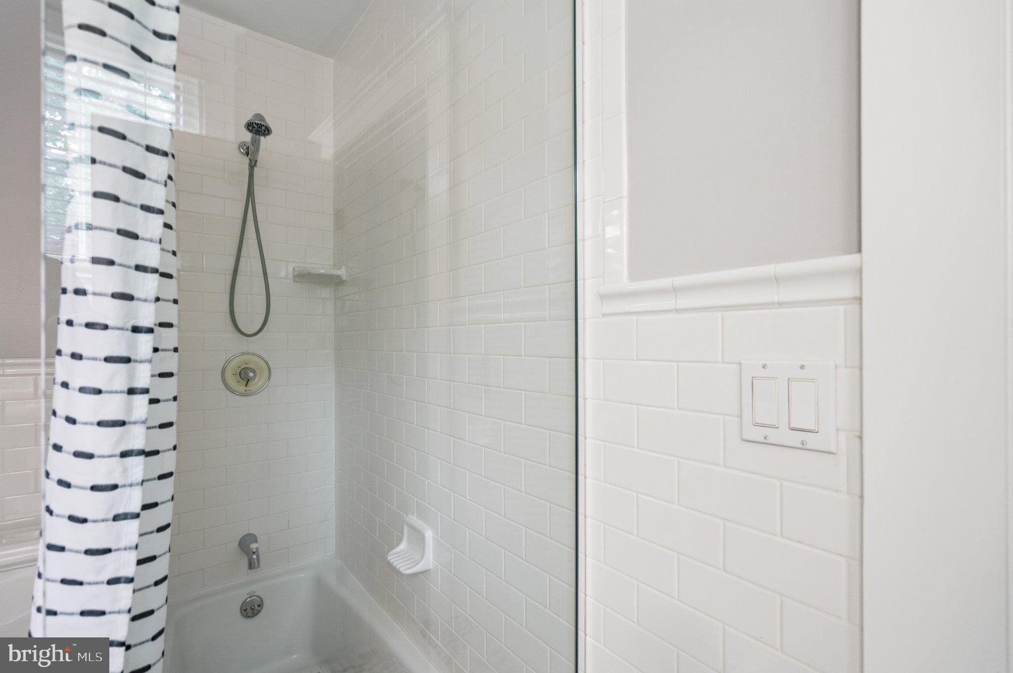 2934 Porter Street Northwest Washington, DC 20008 - Photo 27 of 33 Sleek, modern shower with clean lines.