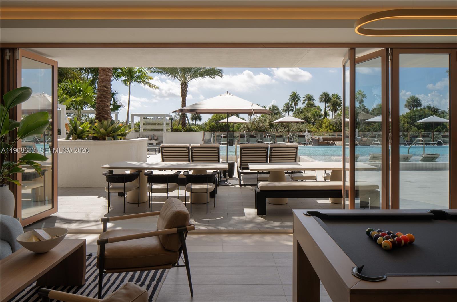 3900 Alton Road, Unit 208 Miami Beach, FL 33140 - Photo 17 of 26 a living room with furniture and a floor to ceiling window