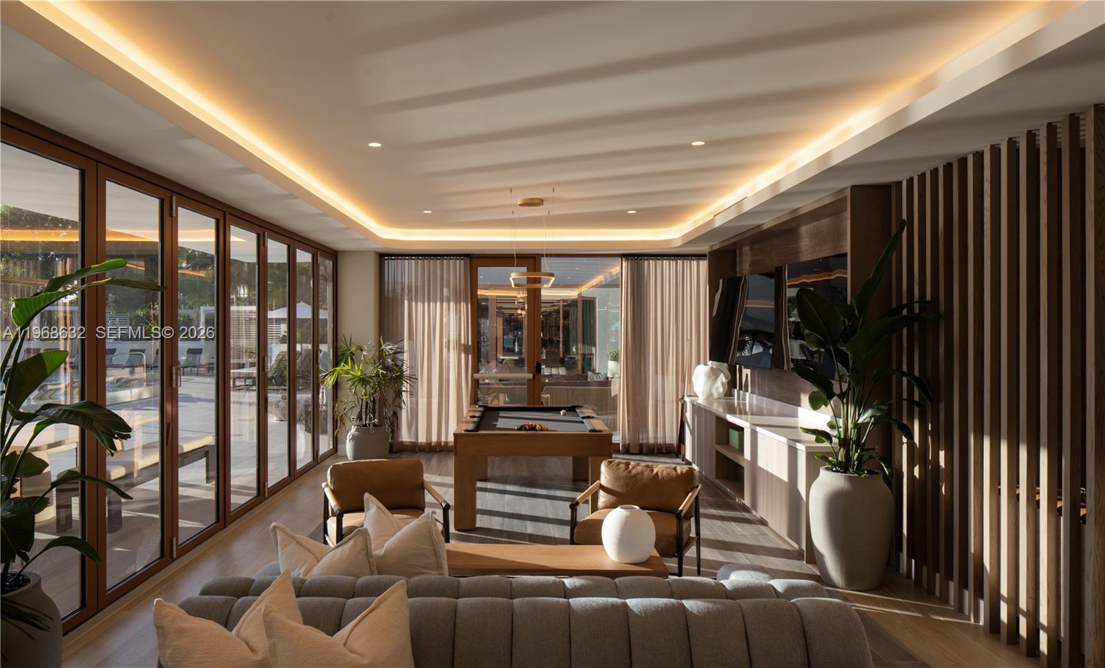 3900 Alton Road, Unit 208 Miami Beach, FL 33140 - Photo 4 of 26 a living room with furniture a floor to ceiling window and floor to ceiling window