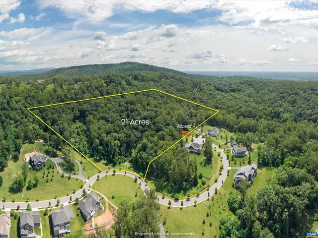 an aerial view of a house a yard and lake view