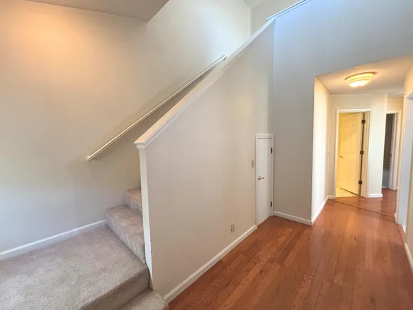 a view of a hallway with wooden floor