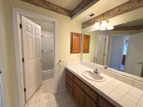 a bathroom with a sink double vanity and a mirror