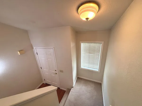 a view of a room with wooden floor and windows