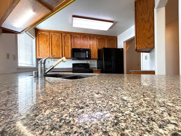 a kitchen with kitchen island a stove a sink and a refrigerator