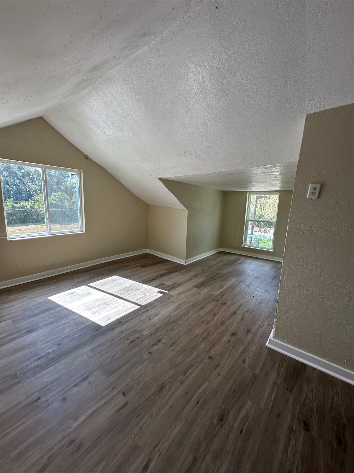 1411 Miles Street Houston, TX 77015 - Photo 11 of 14 an empty room with wooden floor and windows