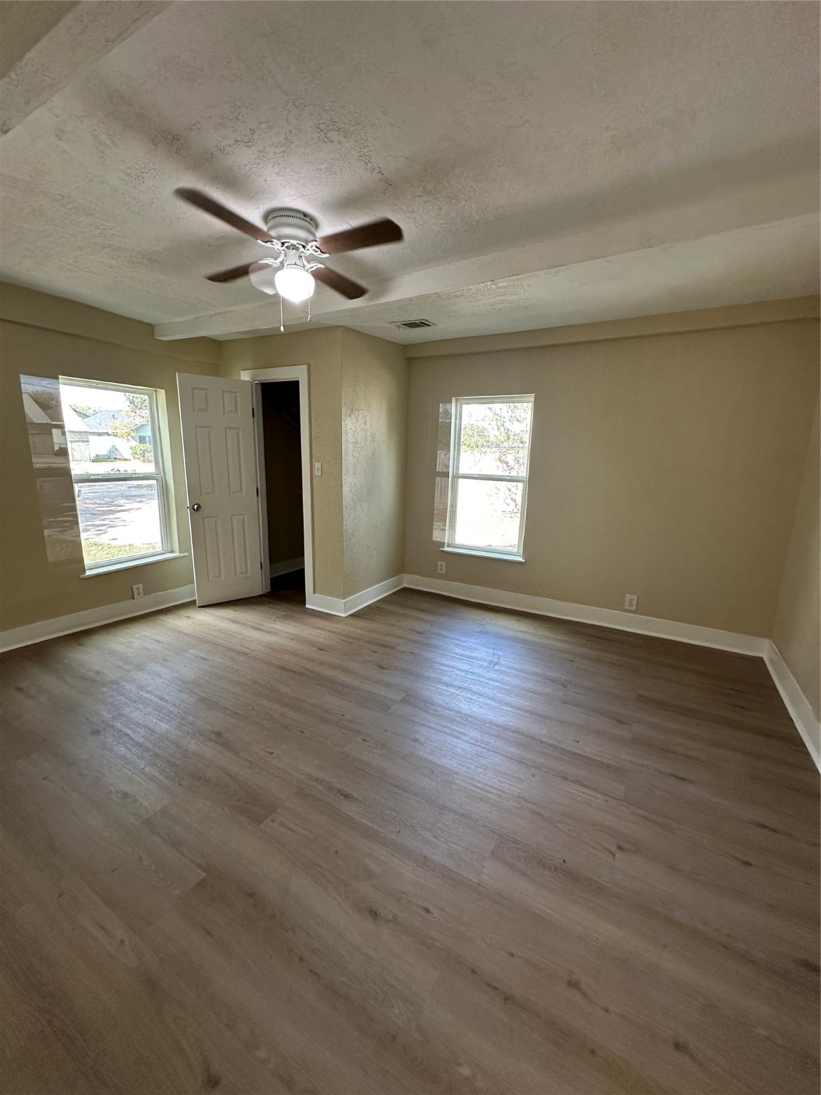 1411 Miles Street Houston, TX 77015 - Photo 14 of 14 a view of an empty room with window and wooden floor