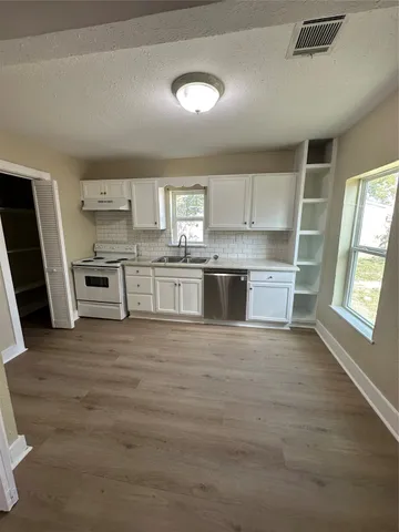 a kitchen with stainless steel appliances granite countertop a stove and a sink