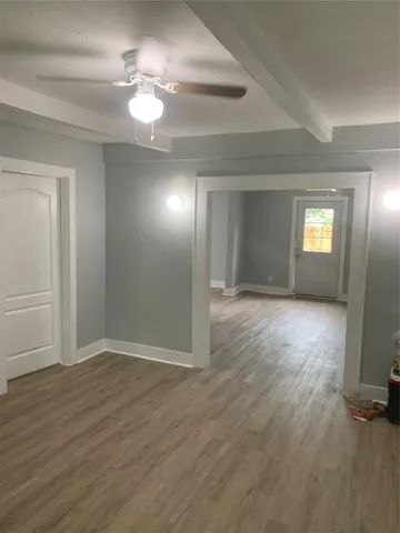 wooden floor in an empty room with a window