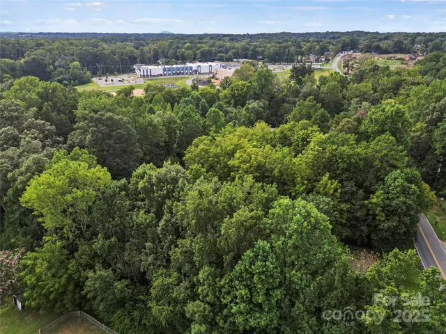 an aerial view of a houses with a yard