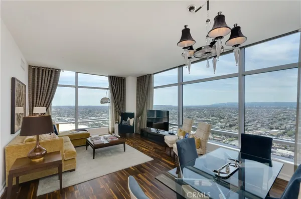 a living room with furniture and floor to ceiling window