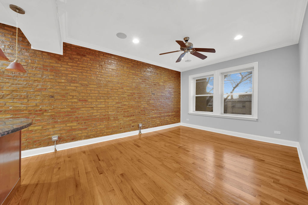 2256 West Arthur Avenue, Unit 2 Chicago, IL 60645 - Photo 6 of 17 a view of an empty room with window and wooden floor