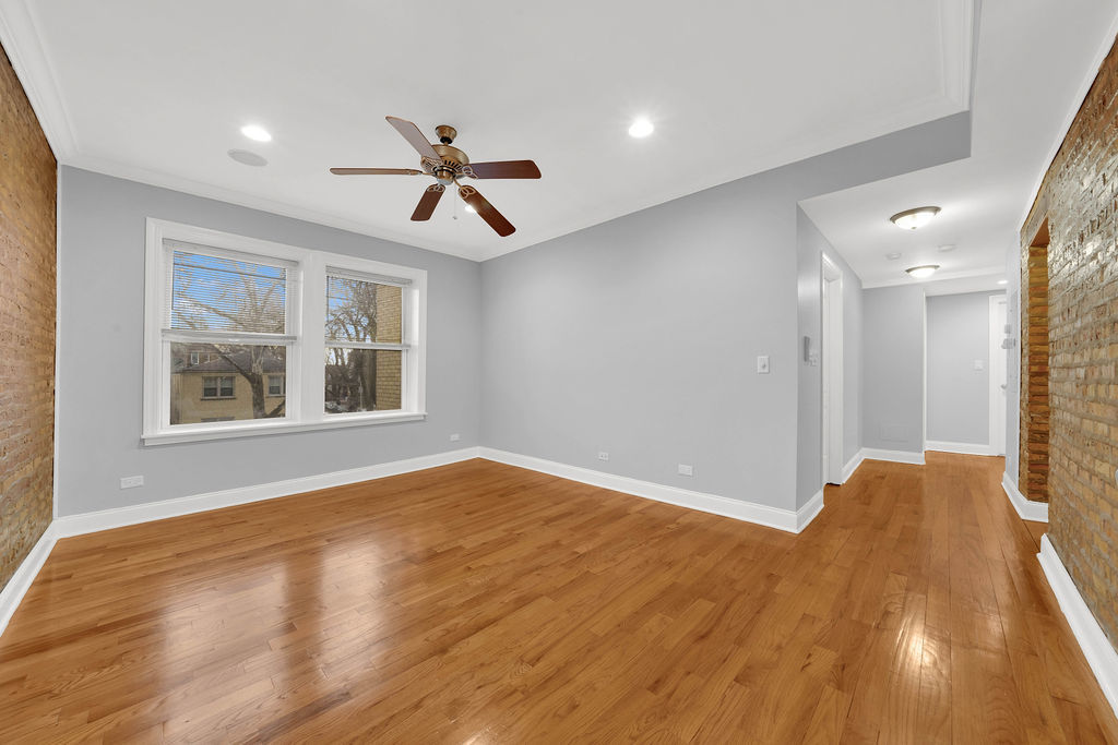 2256 West Arthur Avenue, Unit 2 Chicago, IL 60645 - Photo 7 of 17 a view of empty room with wooden floor and fan