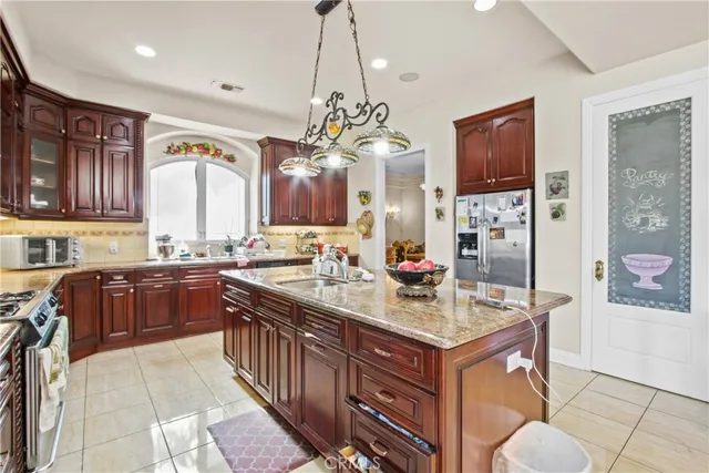 a kitchen with granite countertop a sink stove and cabinets