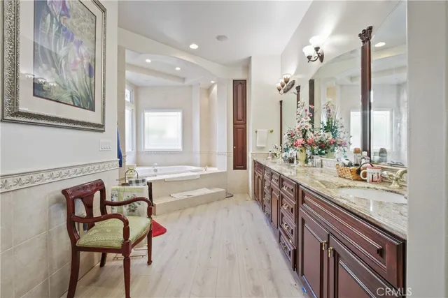 a spacious bathroom with a granite countertop tub and a large mirror