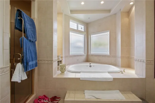 a bathroom with a tub sink and a mirror