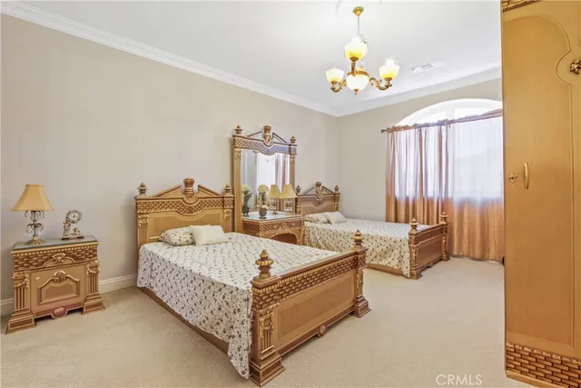 a bedroom with a bed and a chandelier