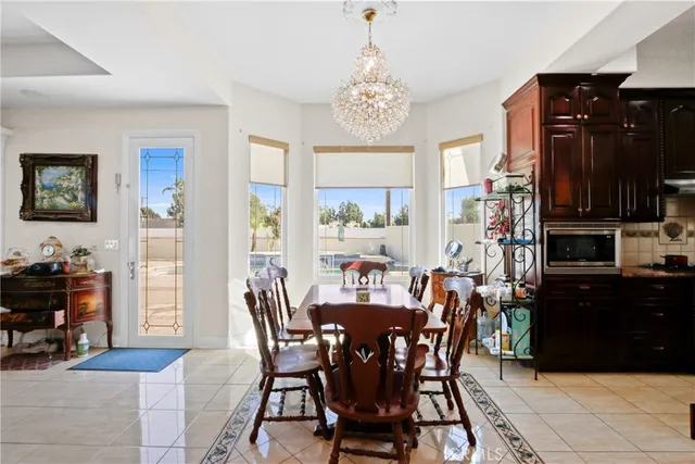 a view of a dining room with furniture and chandelier