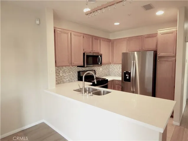 a view of a room with wooden floor and a window