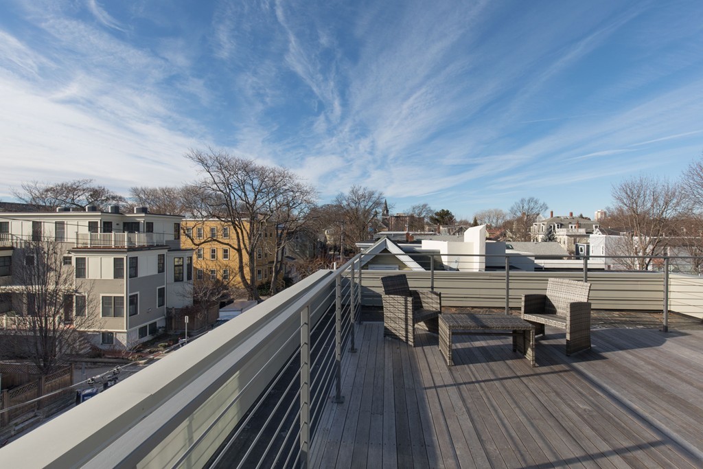 9 Decatur Street, Unit 1 Cambridge, MA 02139 - Photo 11 of 12 a view of a balcony with wooden chairs